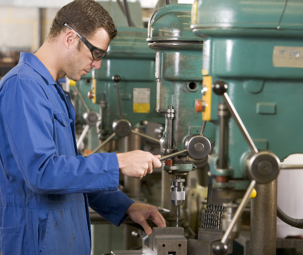 man using drill press